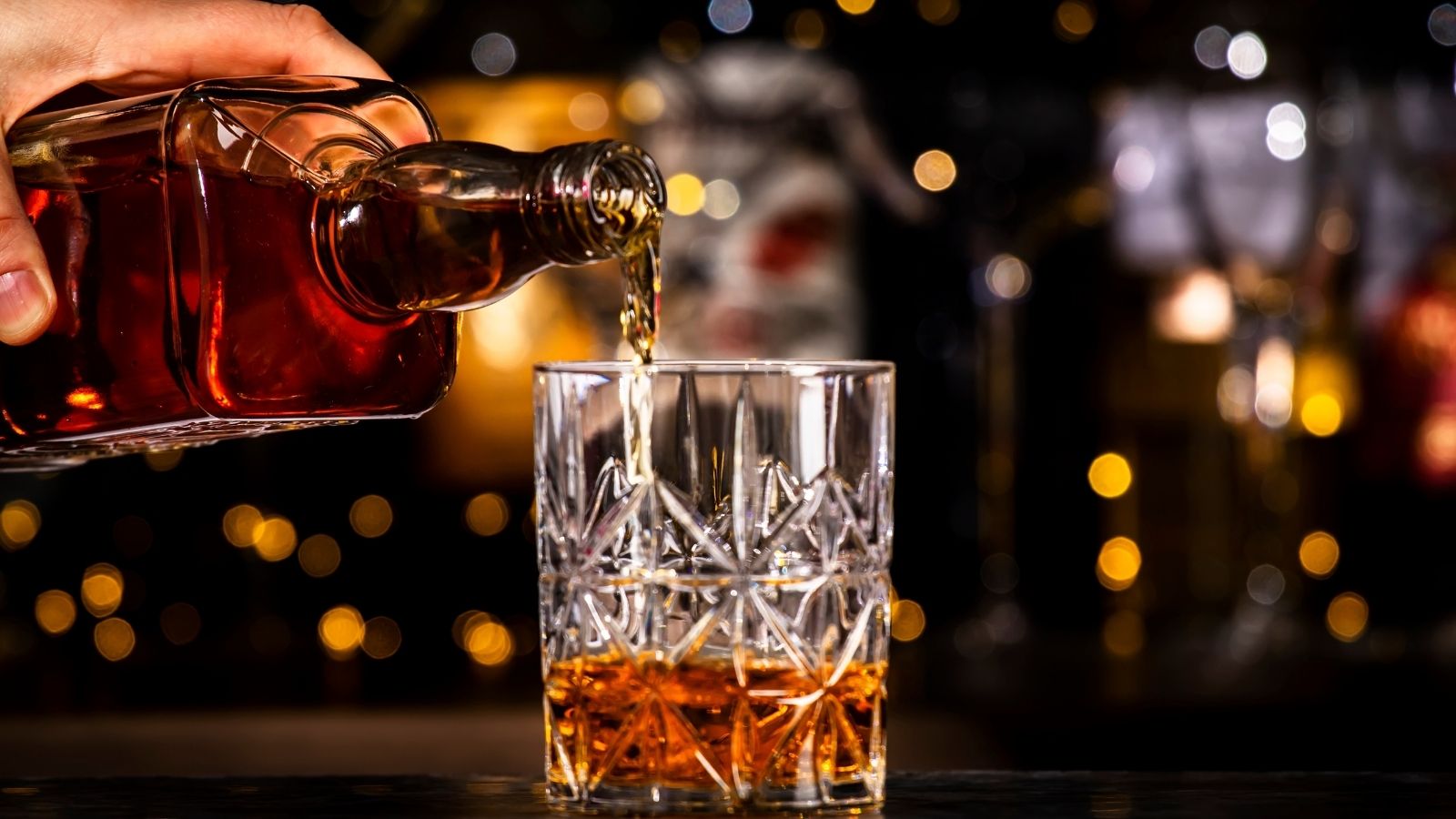 Man Wants His Dad To Ask Before Opening Unopened Bottles From His Alcohol Collection, But His Dad Thinks Its Unreasonable man pouring a glass of bourbon
