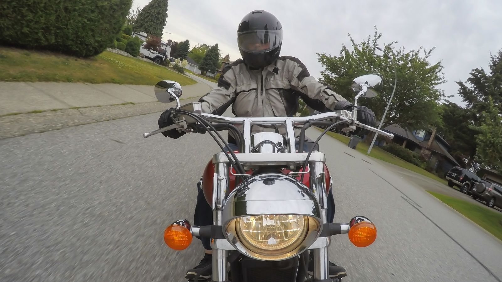 Neighbor Criticized A Biker, But A Woman Stepped In And Defended Both Him And The Neighborhood man riding a motorcycle on a residential street