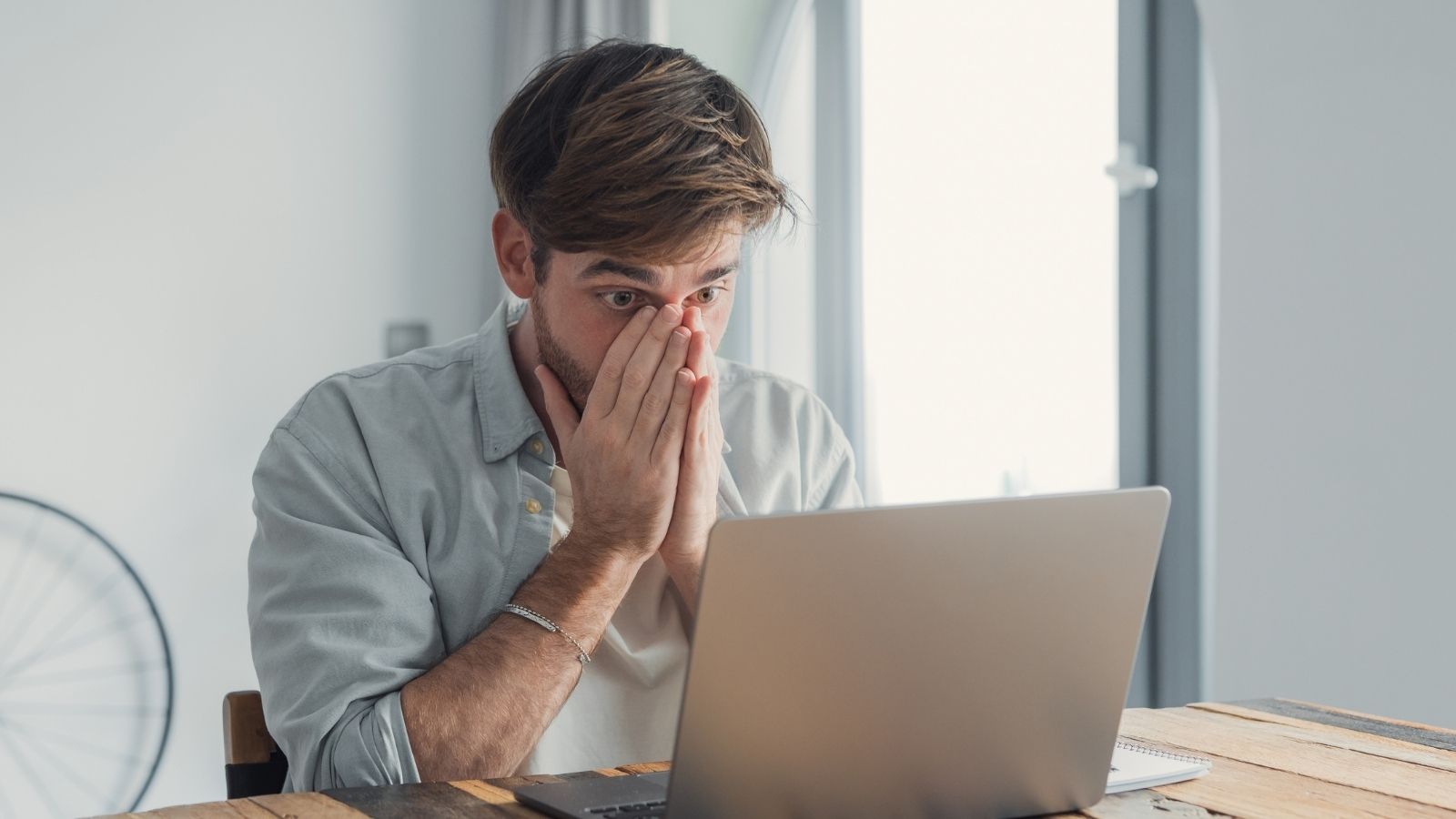 upset man looking at a computer