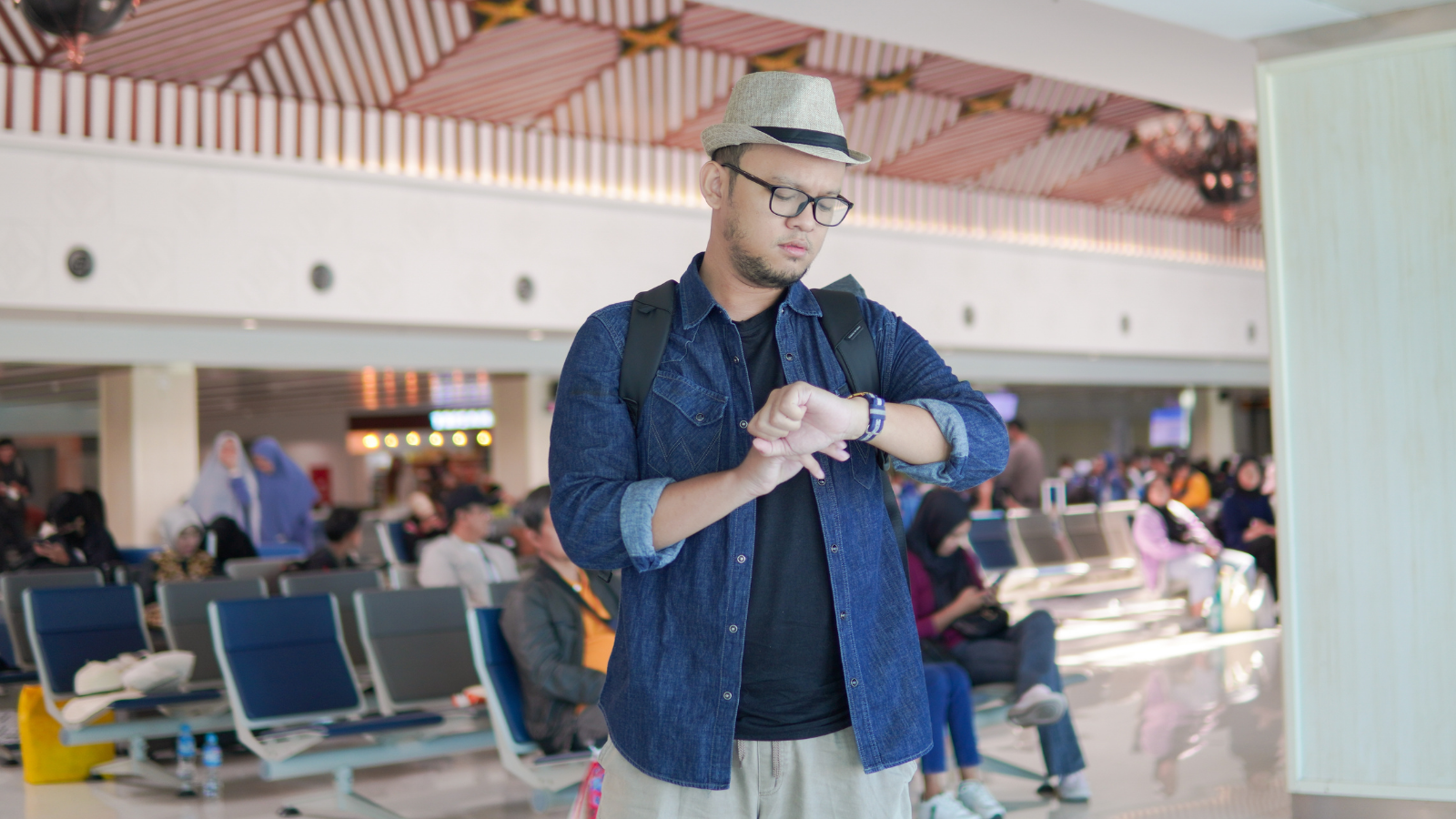 man looking at his watch at the airport