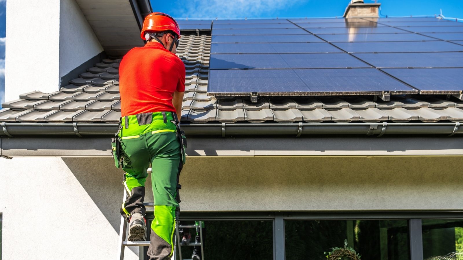 He Installed Solar Panels on His Roof — His Neighbor Reported Him to the City Over It man installing solar panels on the roof of a house