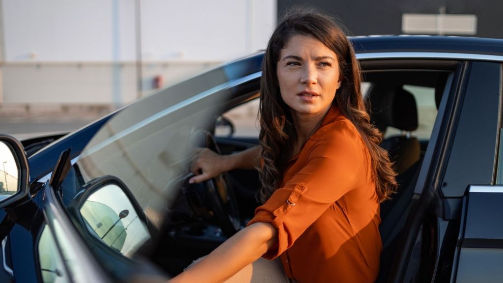 young woman getting in her car