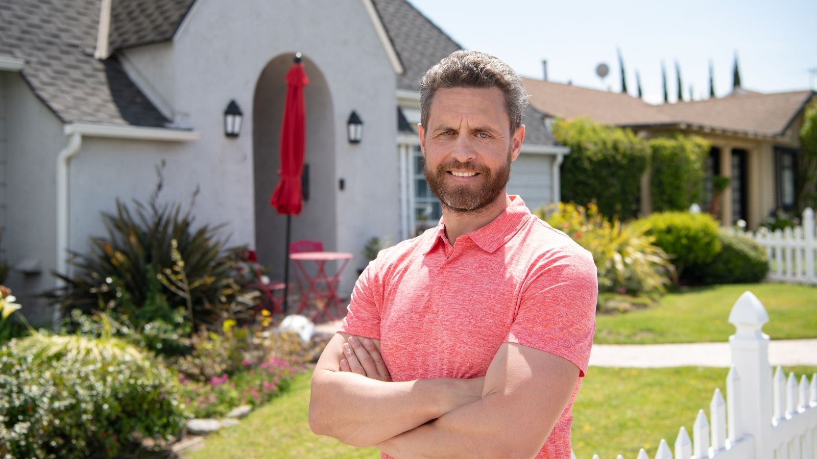 He Didnt Play Along With the HOA Boards Games. Instead, He Blocked Their Worst Idea man standing in front of his house with his arms crossed