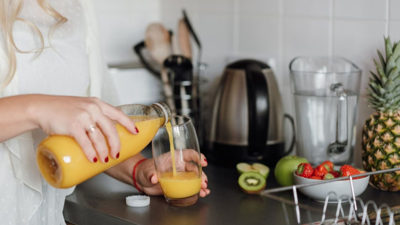 She Had Jaw Surgery and Was Restricted to Liquids—Then Her Husband Weaponized Incompetence to Guilt Her into Cooking His Dinners Woman pouring juice into a glass
