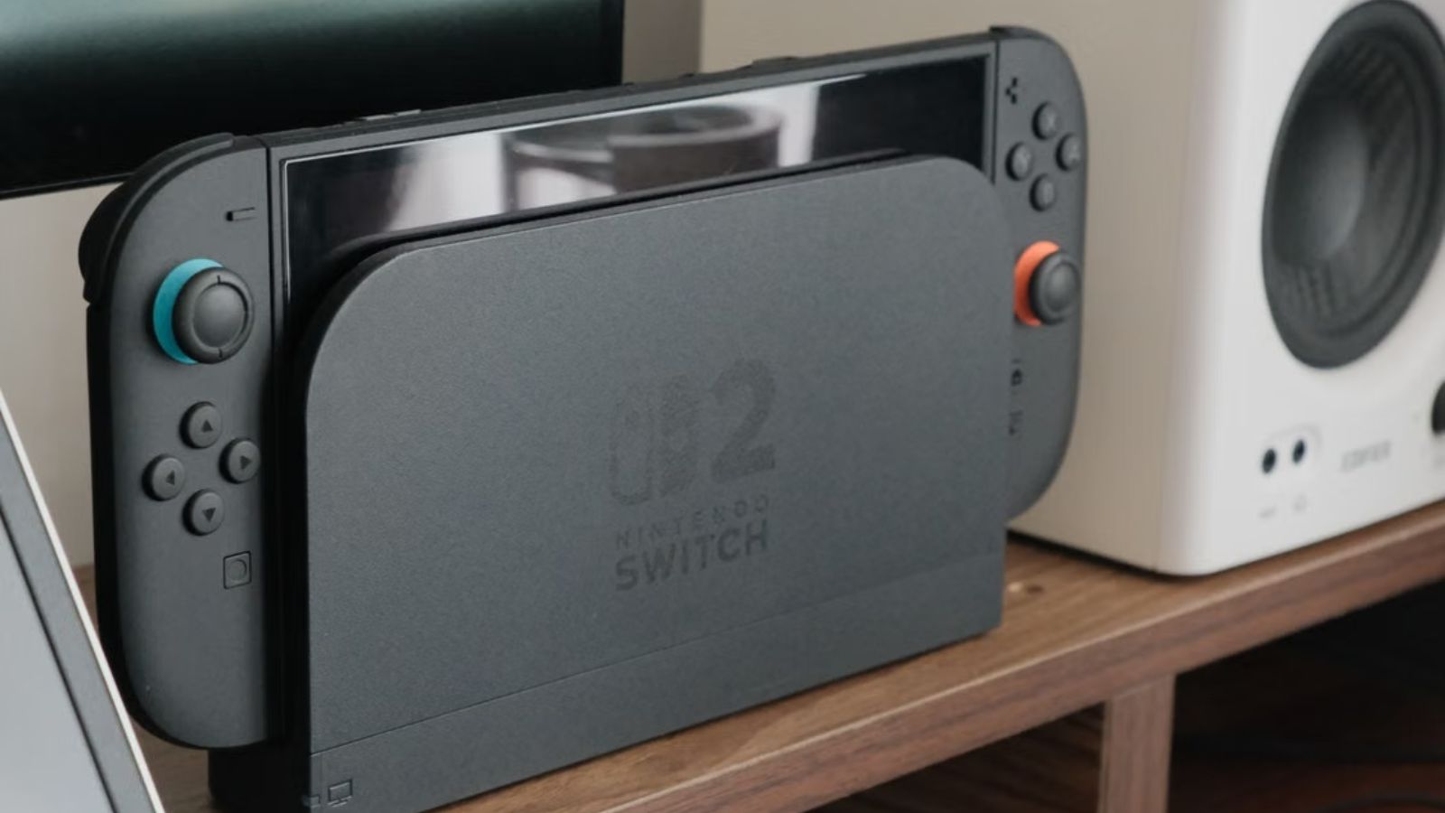 His Dad Threatened to Ban His New Nintendo Switch 2—So the Teen Locked Him Out of the System Nintendo Switch 2 console docked among speakers and a monitor on a wooden shelf