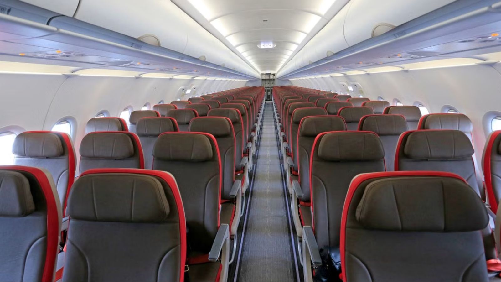 An aircraft cabin with empty rows of seats