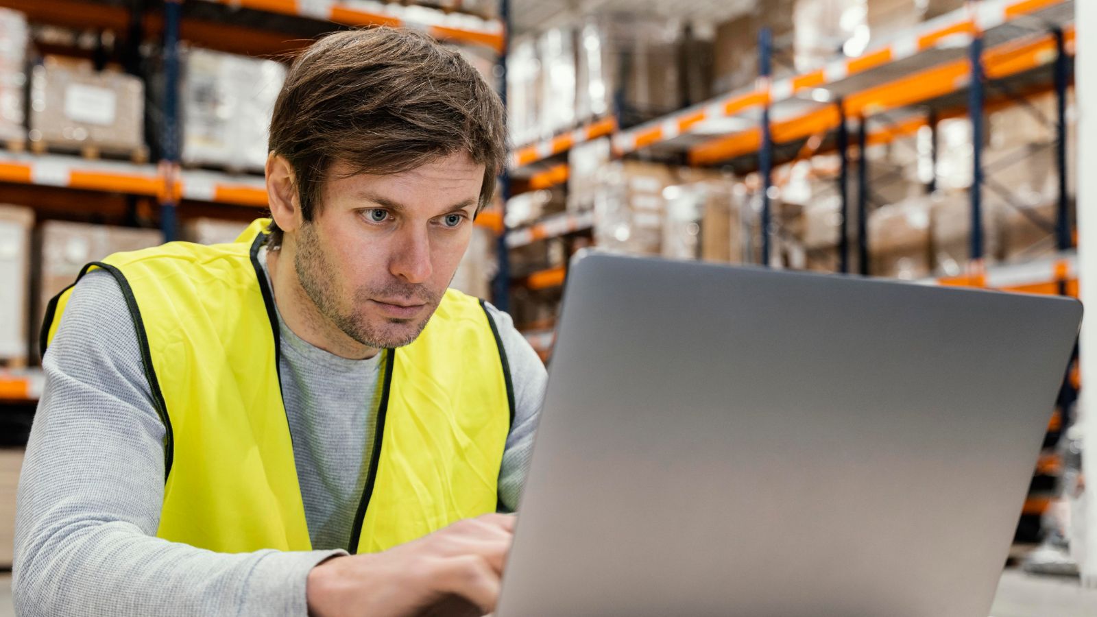 He Flagged a High Value Return with a Forged Receipt and Altered Barcode—Then Stood Back as His Store Manager Handled the Escalating Fraud Man in the warehouse checking the inventory using his computer