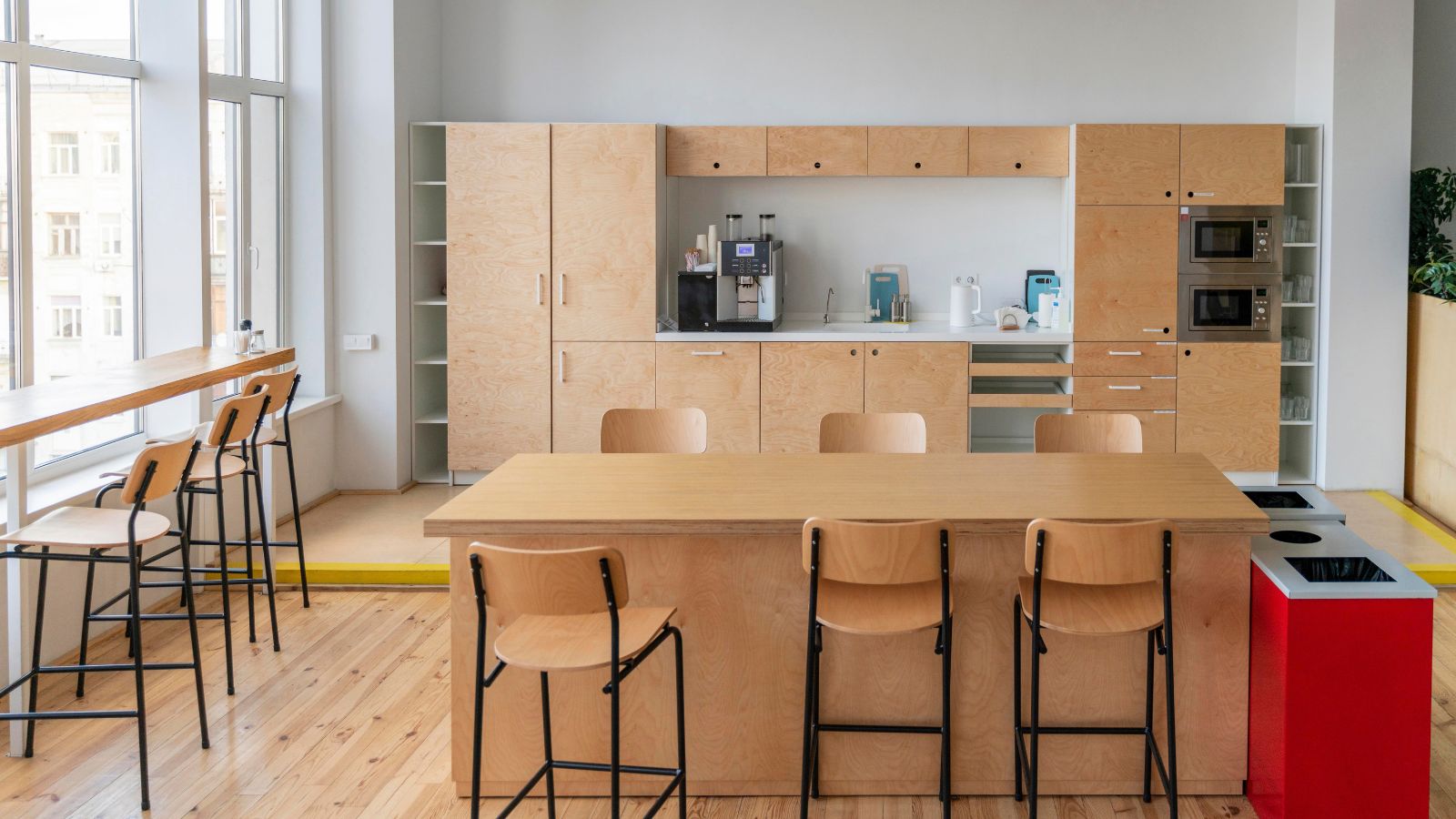 His Company Banned Employees From Taking Snacks And Drinks From The Breakroom, But He Thinks The Rule Is Completely Unreasonable An empty office pantry with tables, chairs, cabinets, and pantry supplies