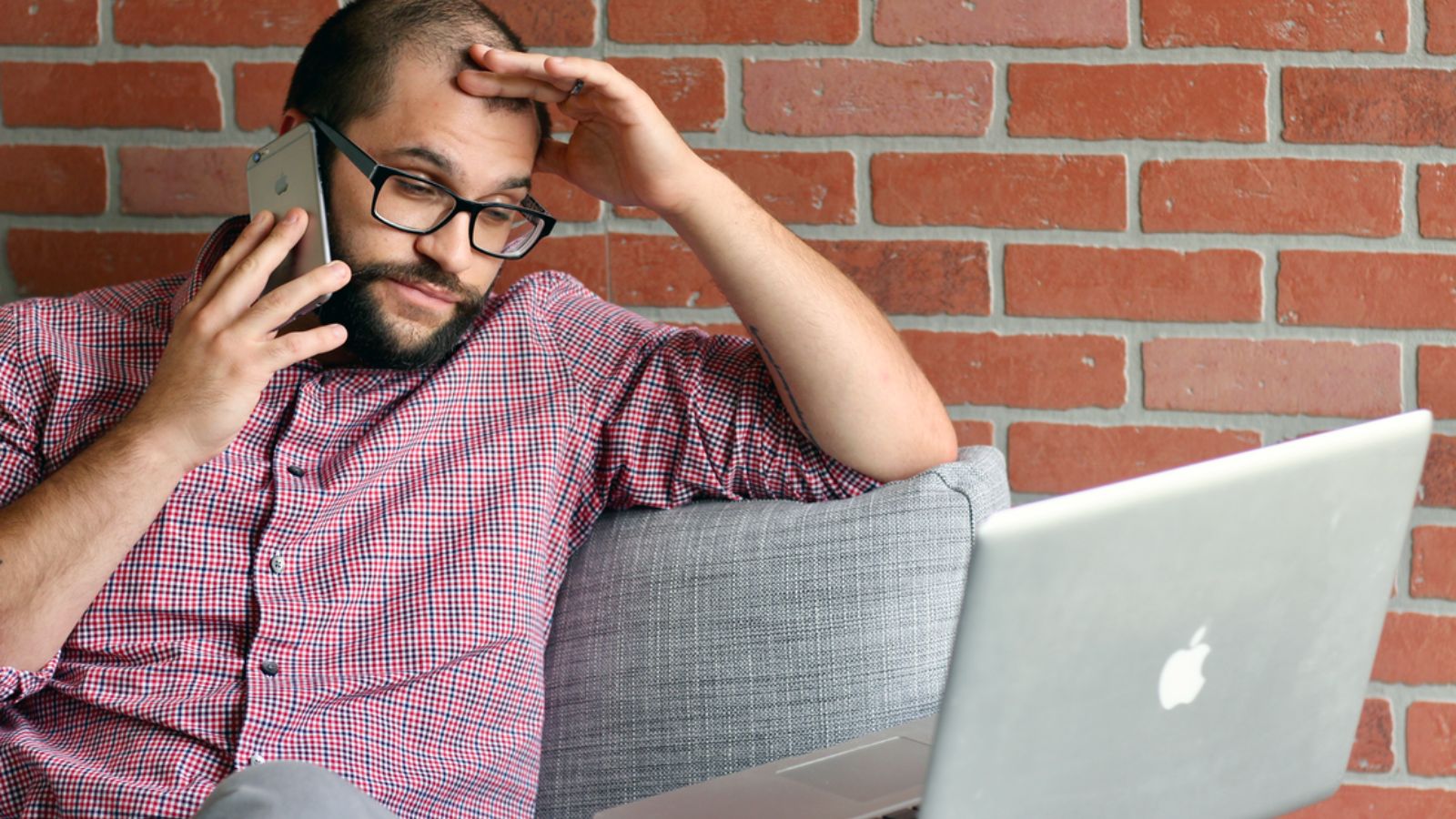 He Filed a $14,000 Wage Theft Claim With the State Labor Board—Then His Ex Boss Threatens a $50,000 Suit for Nondisclosure Violations Man feeling disappointed while talking on the phone in front of his laptop