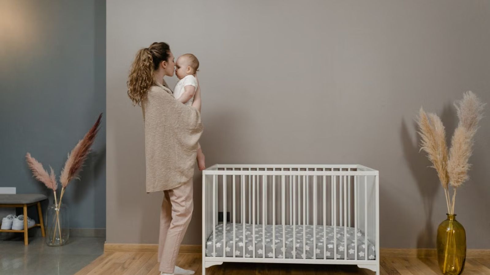 She Spent Weeks Obsessing over Her Babys 2:00 AM Crying Fits—Then Discovered Her Neighbor Didnt Hear a Thing Thanks to Acoustic Wall Proof Mom carrying a baby in an aesthetic room