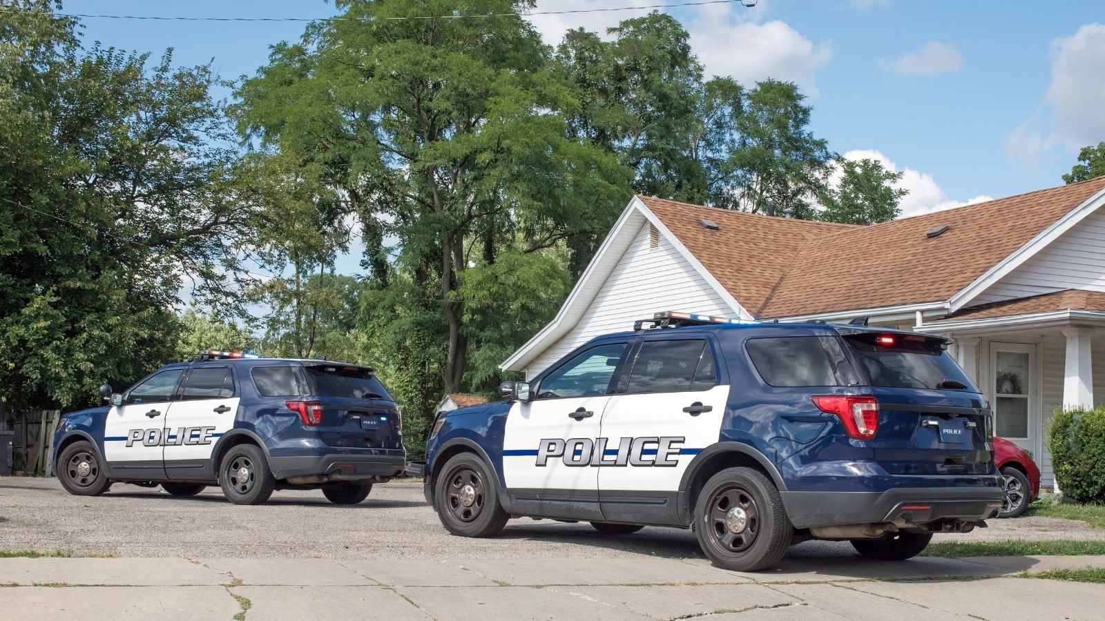 two police vehicles outside a house