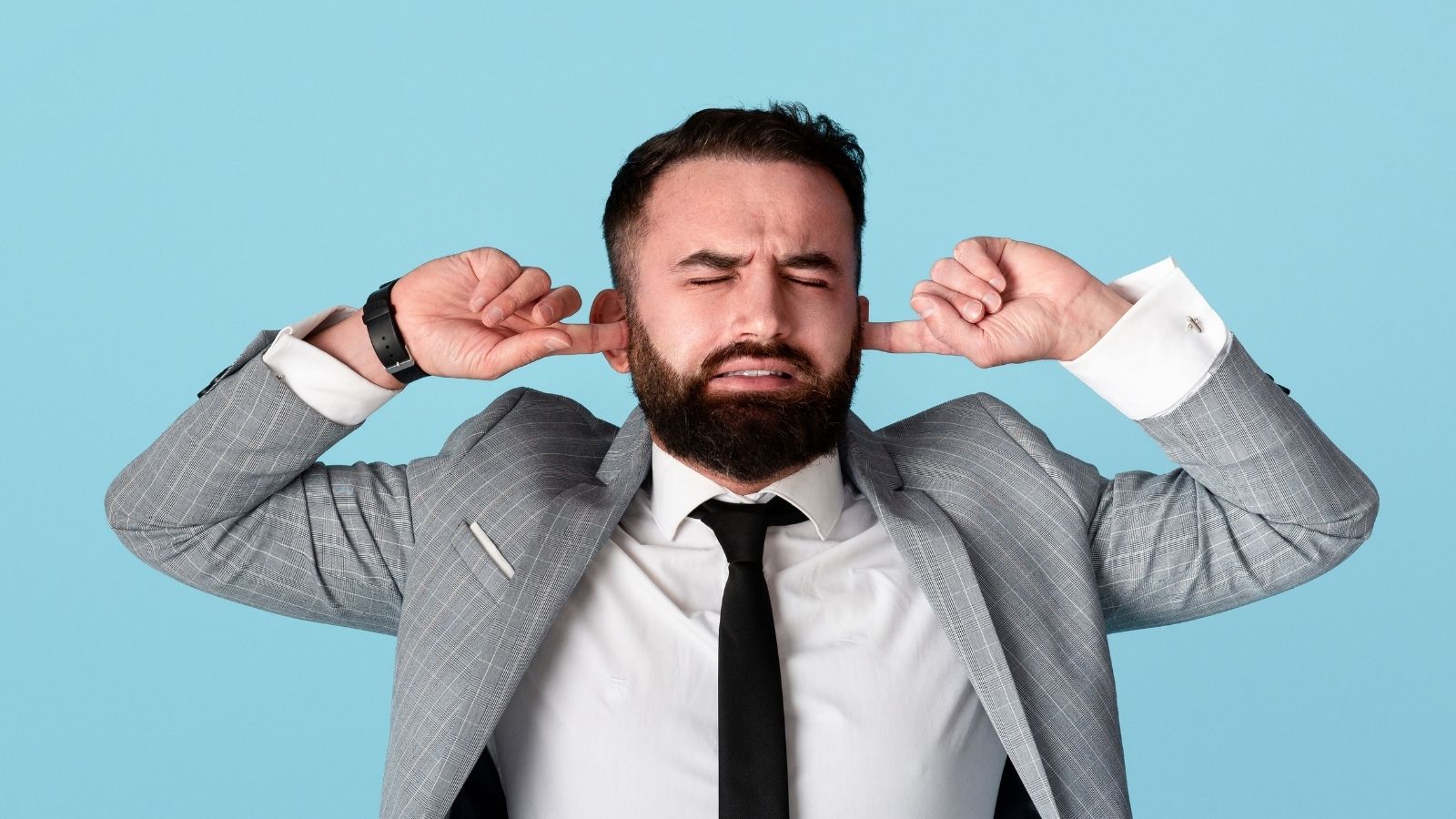 A Mans Office Moved Next to a Leased Church Unit—Now the Loud Worship Service Is Completely Ruining His Workday businessman trying to block out noise with his fingers in his ears