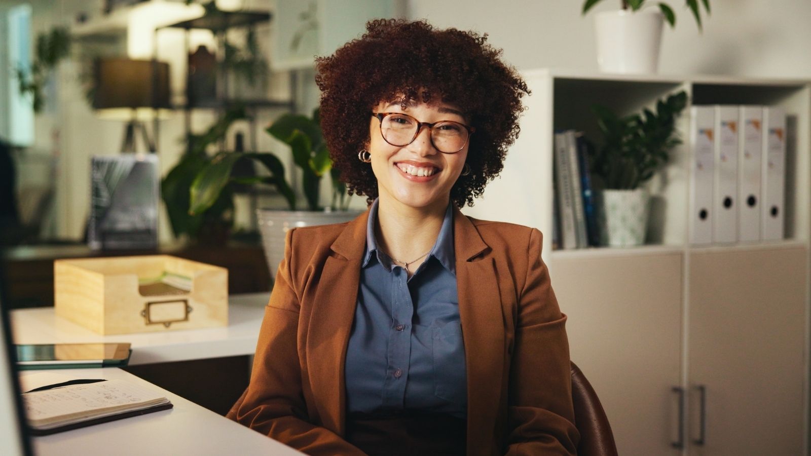Christian Landlord Forces Atheist Tenant to Move Out—But Getting Her Security Deposit Back Is the Real Drama smiling woman in an office