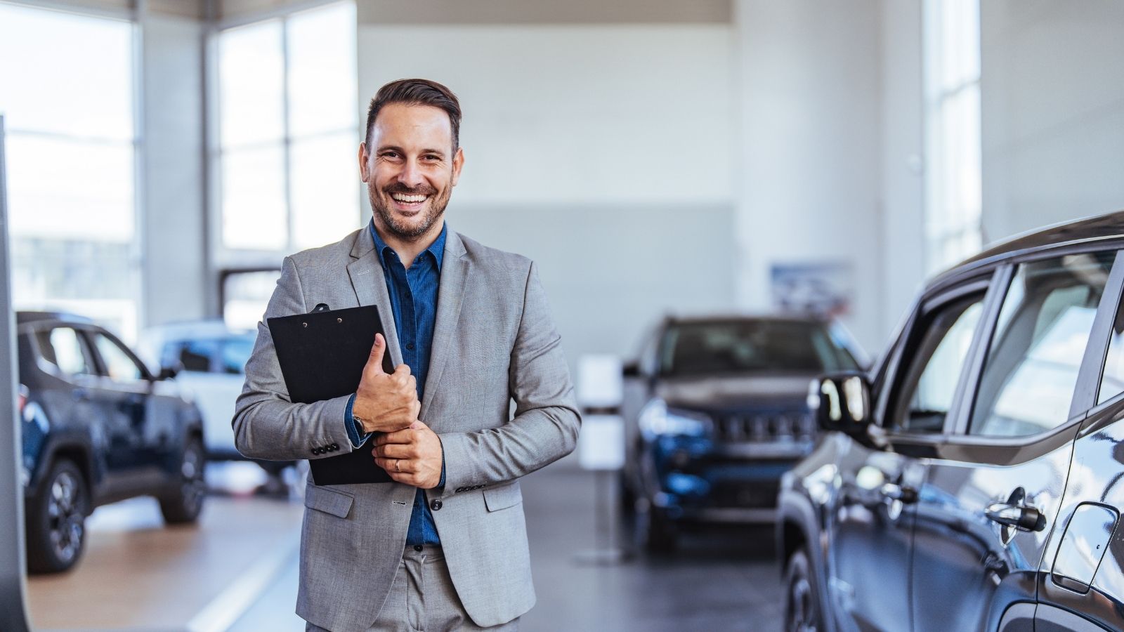 They Hided His Demo Car as a Rookie Initiation—Then Realized He Was Sent by Corporate to Conduct a Dealership Audit smiling car salesman