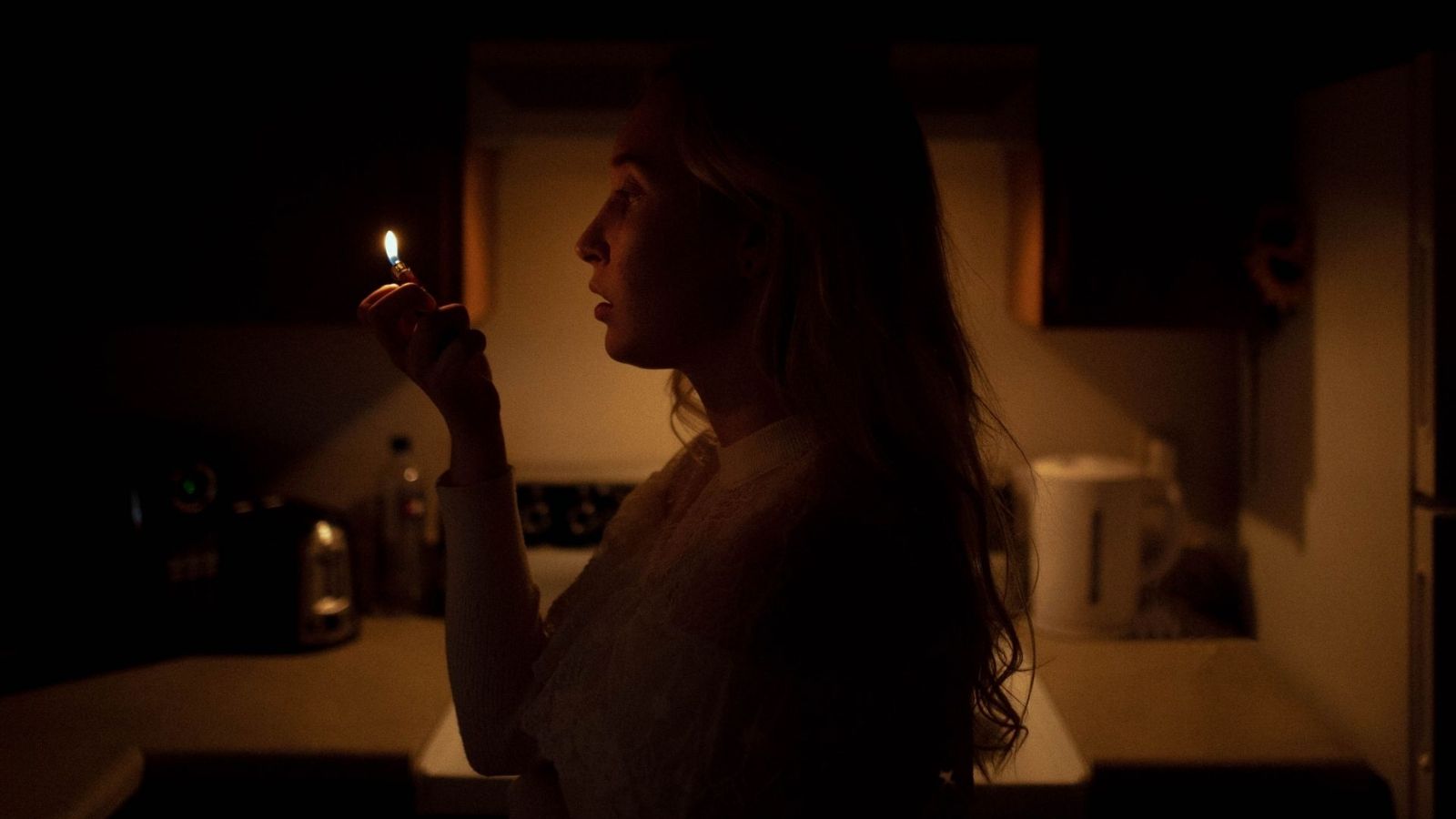 Woman holding a lighter indoors