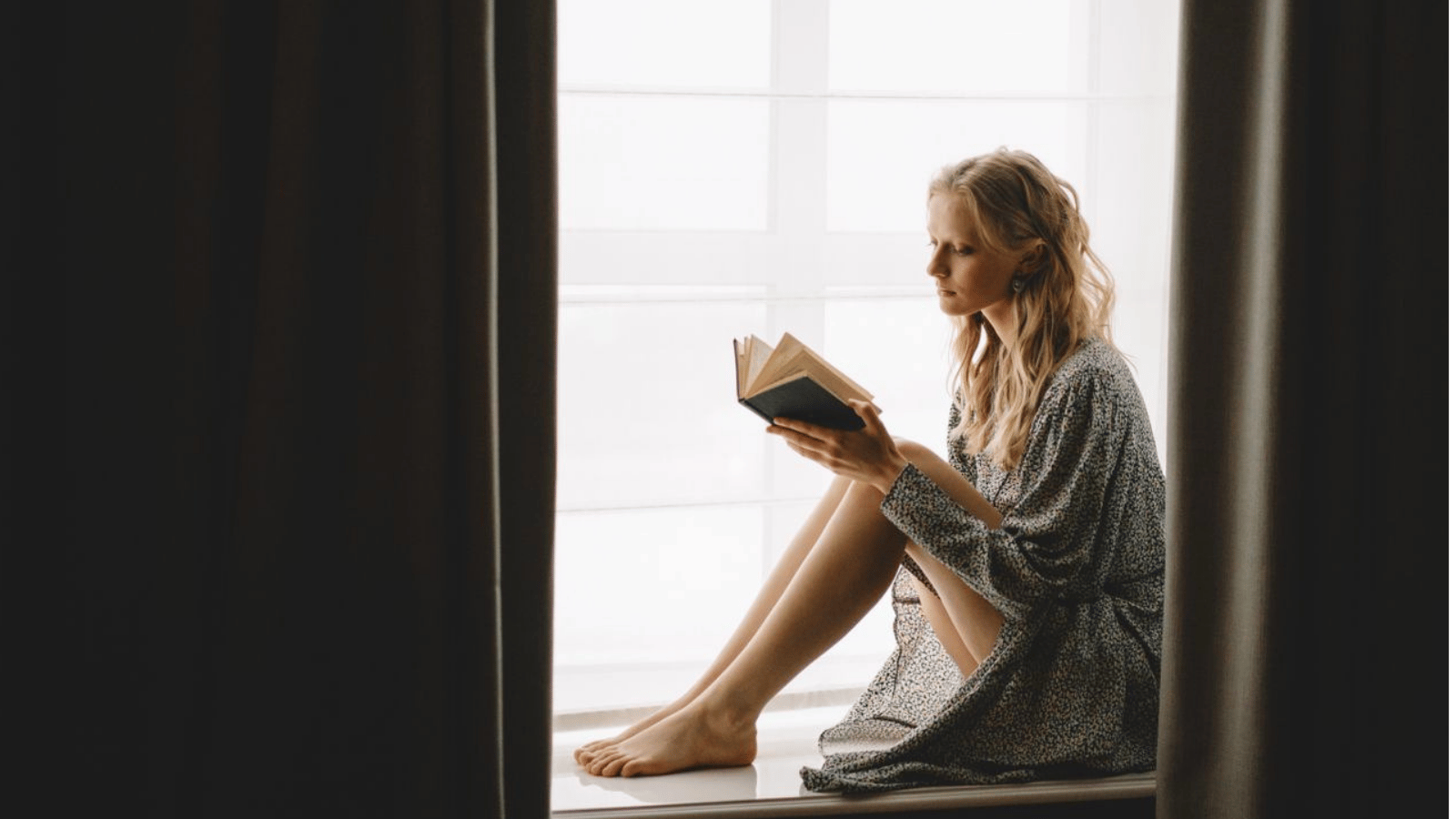 She Refused to Lend a Rare Book to an 8 Year Old—and Was Instantly Called Childish by Her Friend Woman reading sitting on windowsill