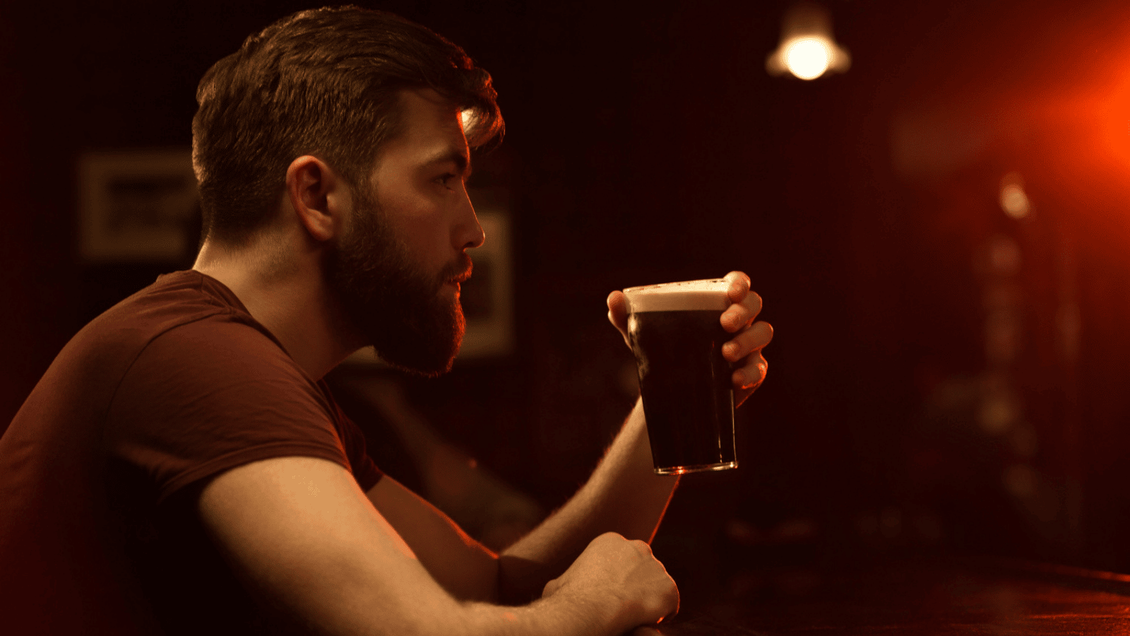 Attractive man drinking at a bar