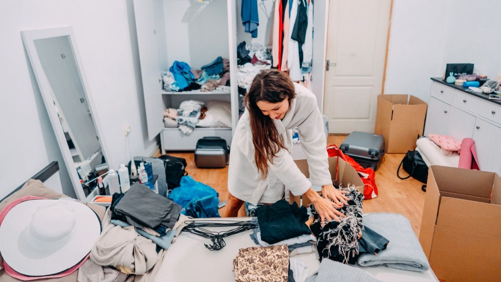 Her Sister Moved Back Home and Stole Her Entire Closet—Then Their Mom Told Her Tough Luck Woman organizing her clothes