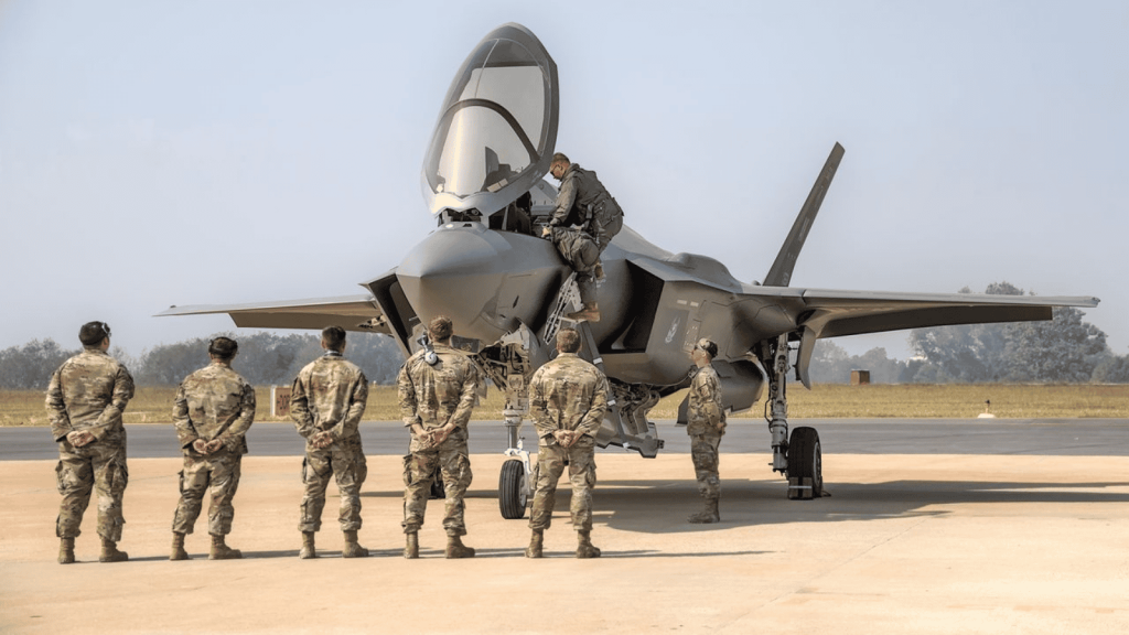Airmen looking at fighter jet