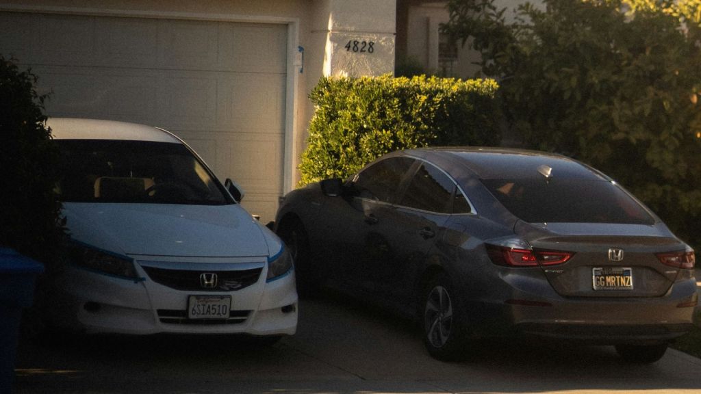 Two cars parked on a property's driveway