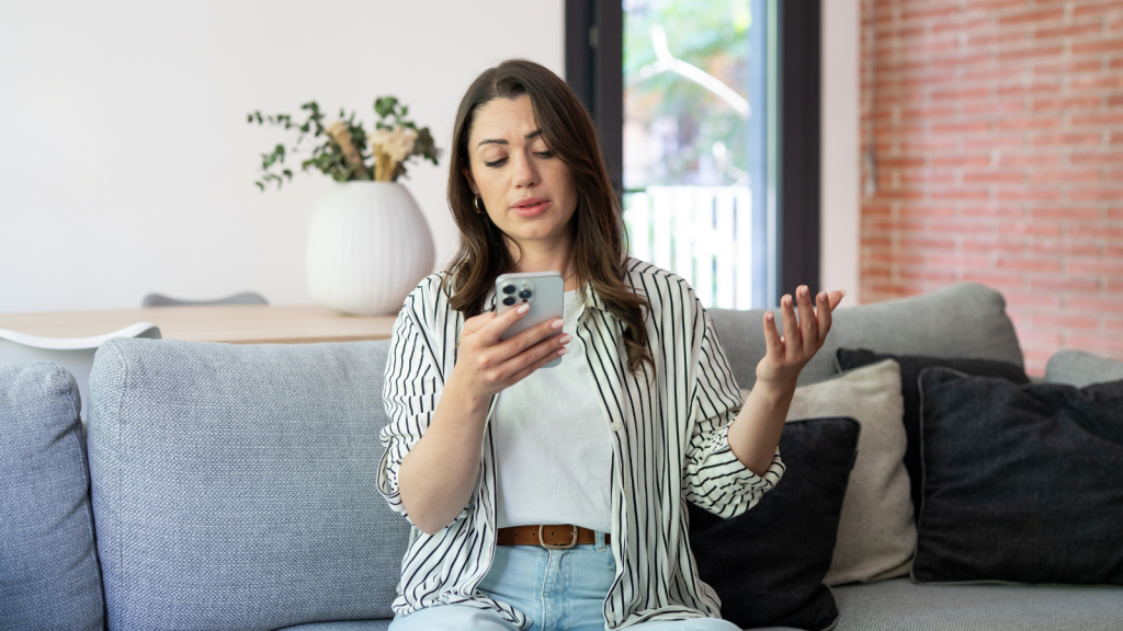 Young Woman Says Her Stepmom Has Treated Her Poorly For Years, But Now Her Dad Is Pressuring Her To Visit Their New House Woman looking annoyed while on the phone