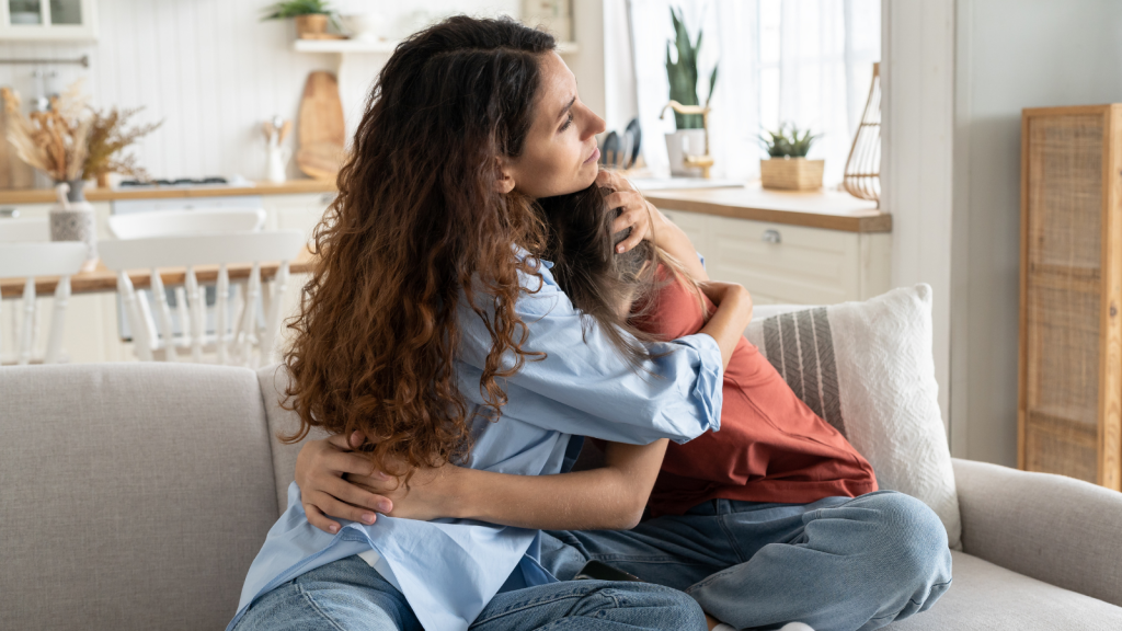 She Intervened to Protect Her Youngest Sister from Financial Exploitation—Then Her Middle Sister Declared Open War Younger girl crying to a woman who's hugging and comforting her