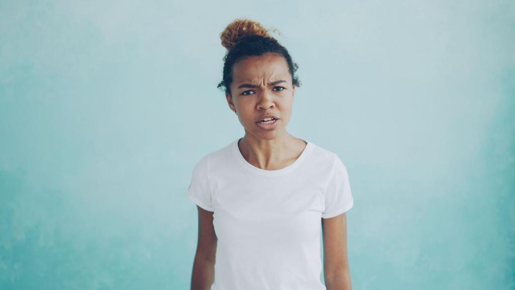 angry woman against a blue background