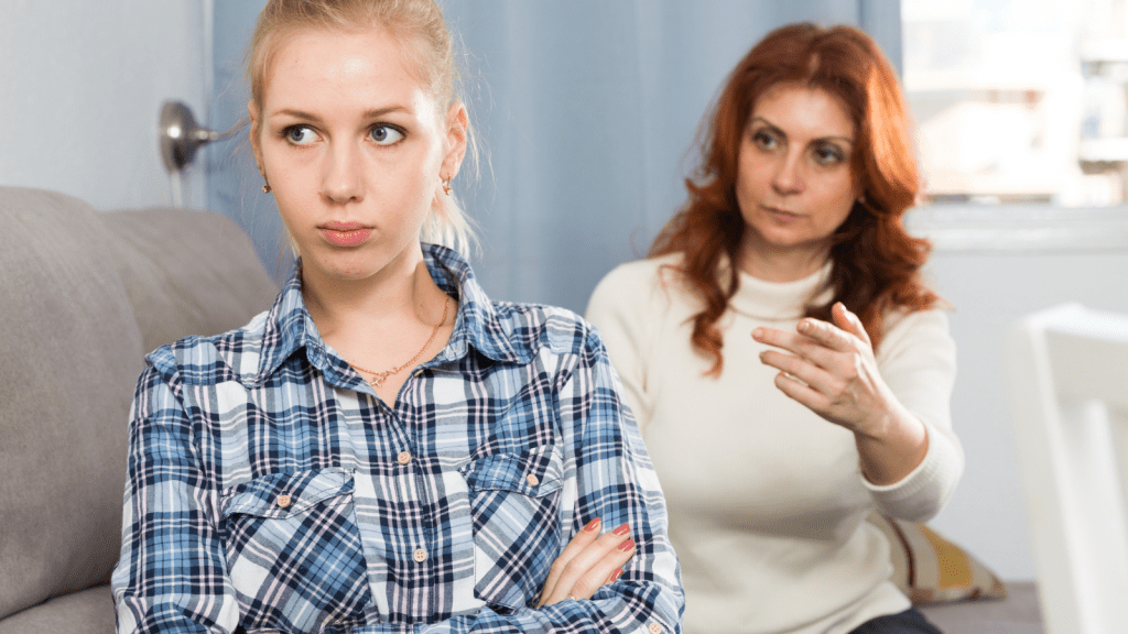 She Was Counting On That Money To Stay Enrolled, Yet Her Mother Used It Before The Tuition Deadline Arrived angry young lady sitting next to confused mom