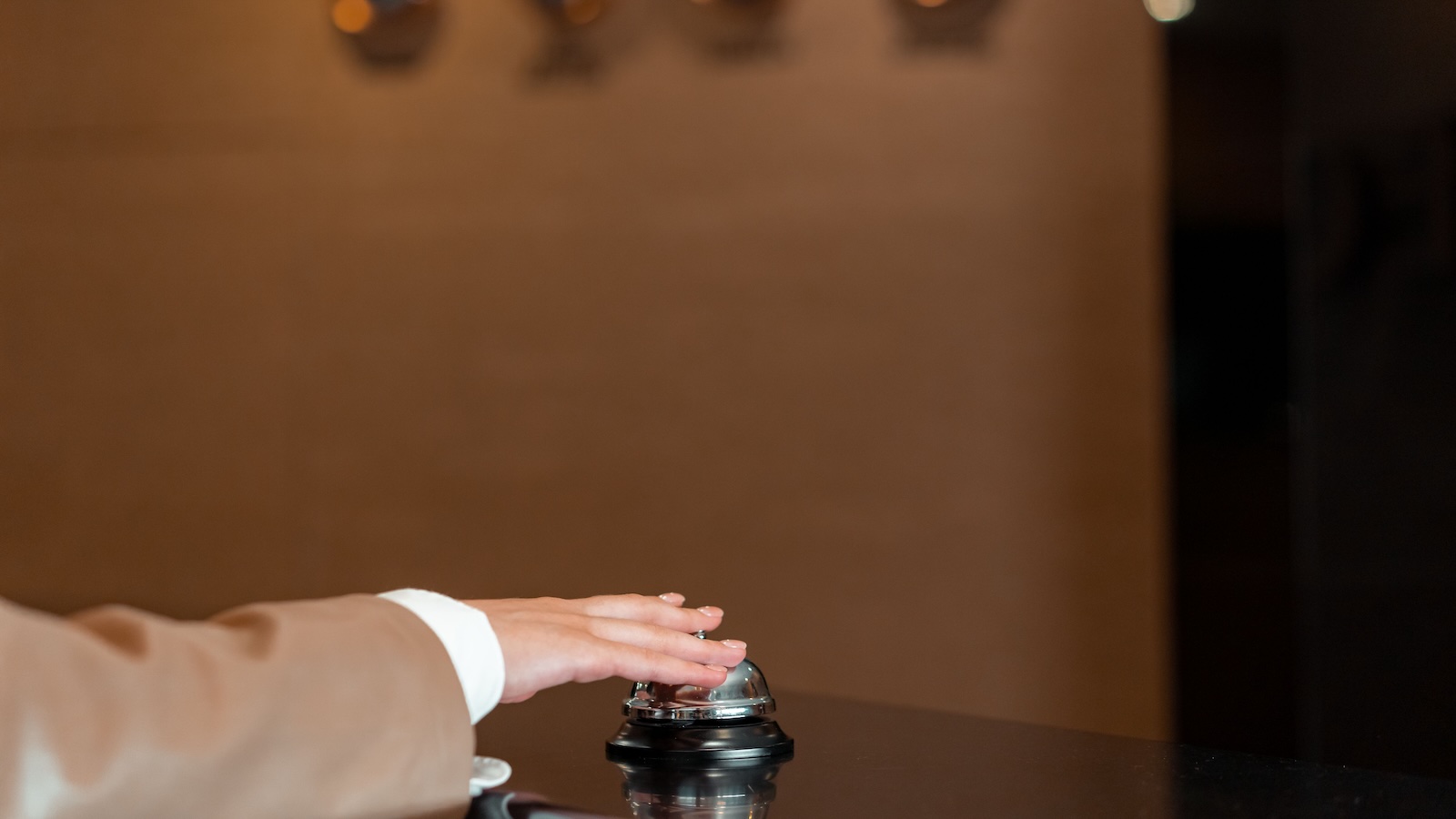 Hotel Guest Praises A Front Desk Employee For Handling His Constant Complaints, But His Final Reviews Get Him Banned customer ringing a bell in a lobby for assistance