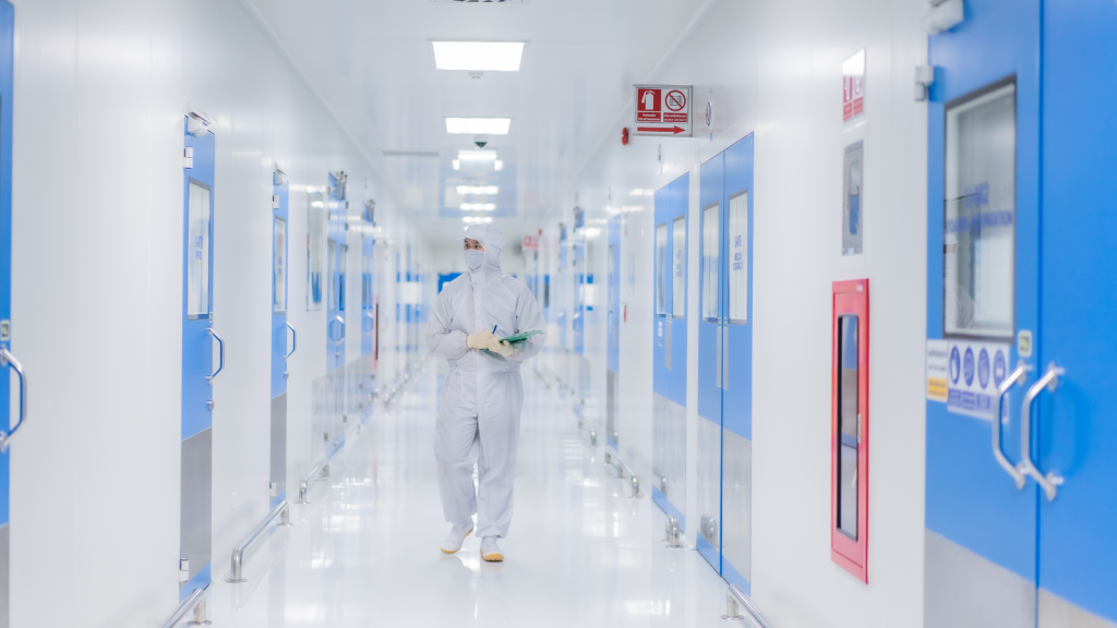 Employee Rushed To Deliver Raw Materials Exactly As His Manager Ordered, But Following The Instructions Left Both Of Them Trapped Inside An Airlock big pharma worker walking through sterile hallways
