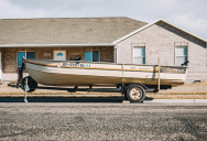 Homeowner Got Fed Up With A Pushy HOA President’s No-Parking Rules, So He Parked His Boat Outside Her House And Left It There For Years