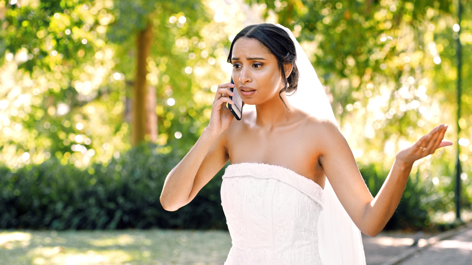 She Declined a Role in Her Friends Wedding to Set Boundaries—Then Accepted the Exact Same Spot in Another Wedding Soon After bride having difficult discussion on the phone outside