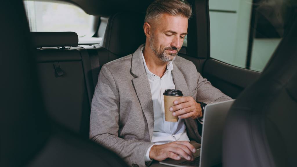 He Thought Cutting Company Cars Would Save Money — His Employees Response Cost Him Even More businessman in the backseat of a car