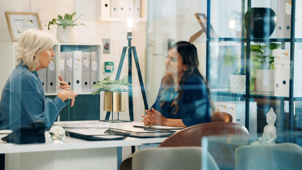 businesswomen in meeting behind glass walls