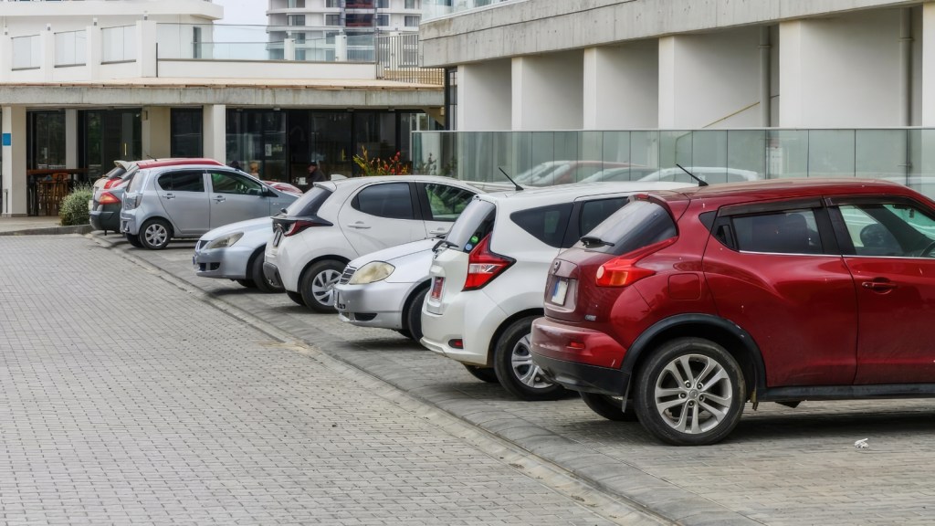 One Resident Is Growing Frustrated After Repeatedly Finding A Stranger’s Car In The Parking Spot That Comes With Her Apartment cars parking next to an apartment building