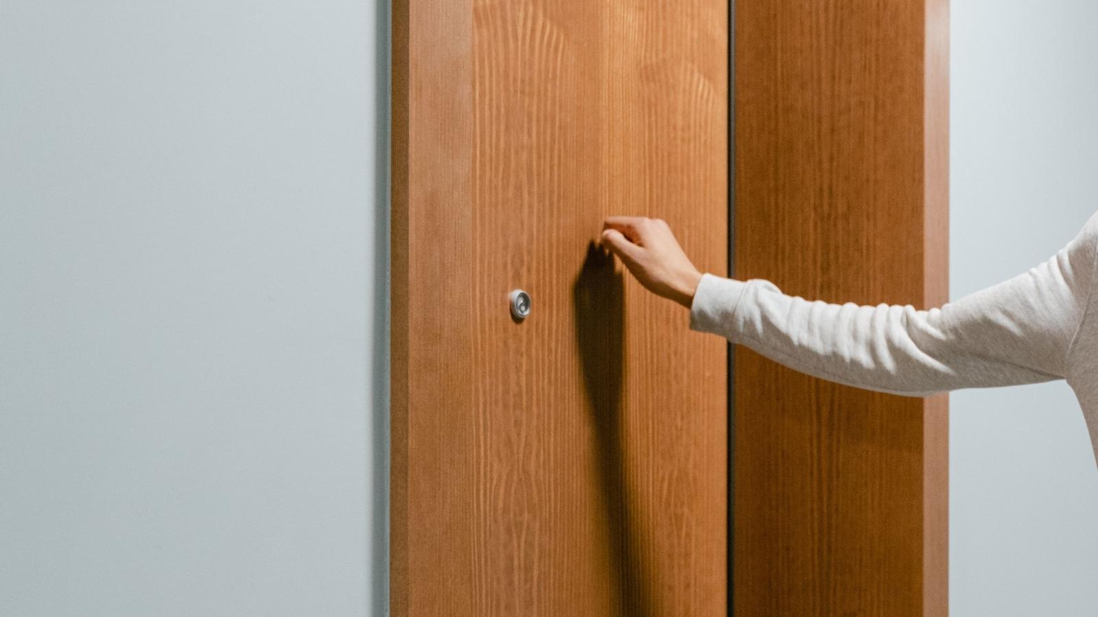 closeup of person knocking on the door