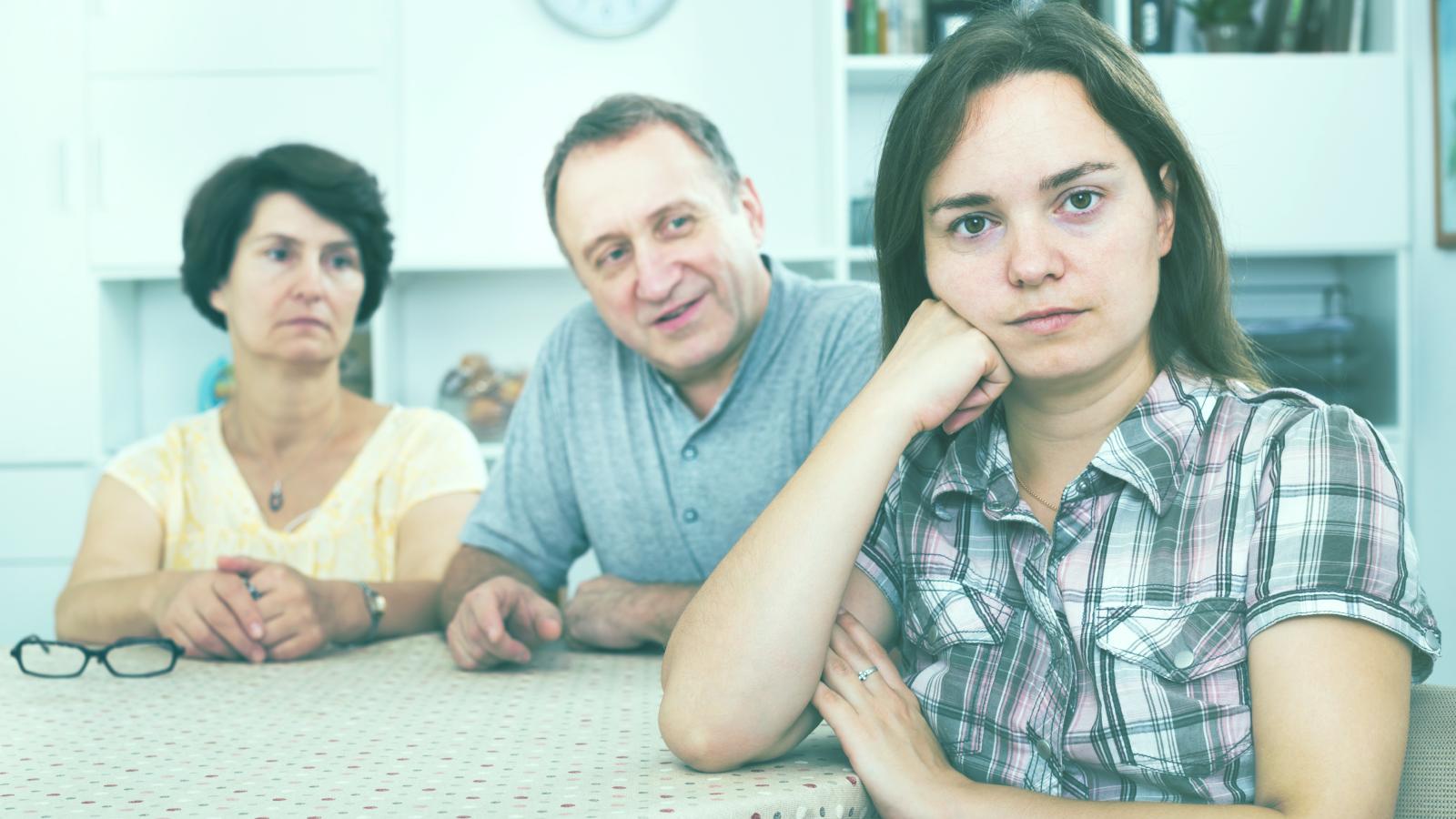 She Qualified for a Fully Funded STEM Doctorate—Then Her Parents Demanded She Take a Local Desk Job to Pay Her Older Brothers Debts woman with her parents