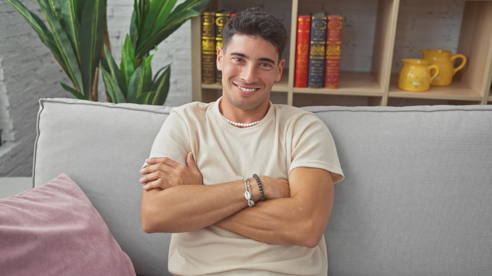 His Landlords Tried to Screw Him Over—So He Fought Back, and It Took Them Nearly a Year to Sell the Place man sitting on a couch