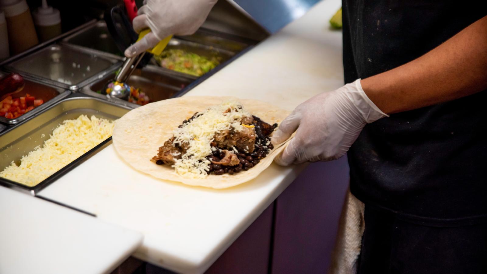 A Customer Freaked Out Because His Burrito Wasnt Wrapped In A Very Specific Way worker making a burrito