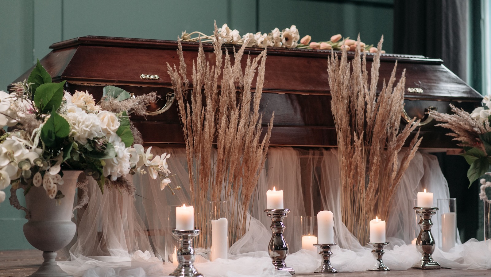 Her Father Asked to Be Scattered in the Pacific—Then She Feared a Memorial Locket Would Betray His Legacy casket with candles, straw and more