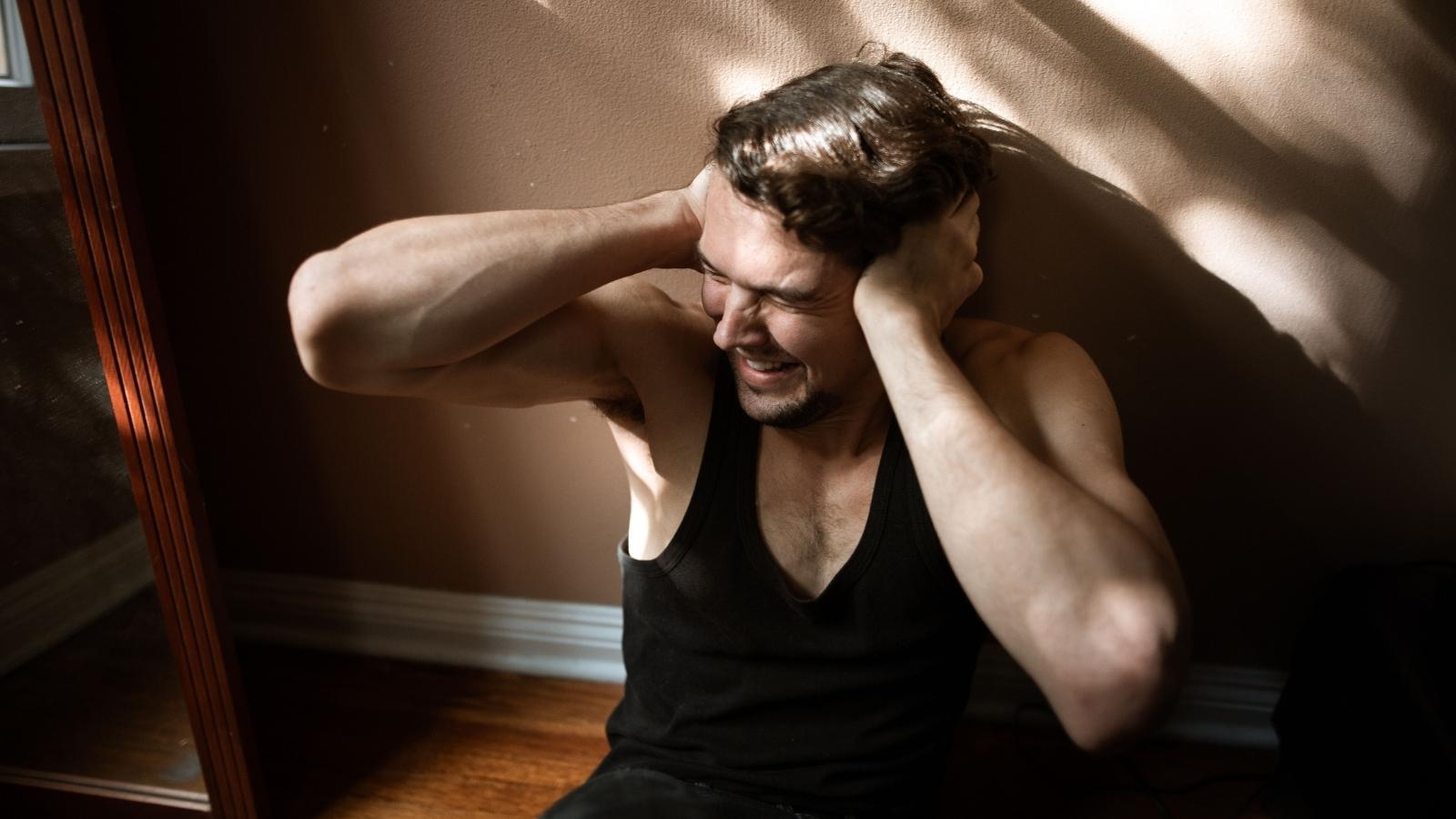 Neighbors Mysterious Midnight Hum Kept An Entire Block Awake, But One Tenant Couldnt Figure Out Where It Was Coming From distressed man covering his ears