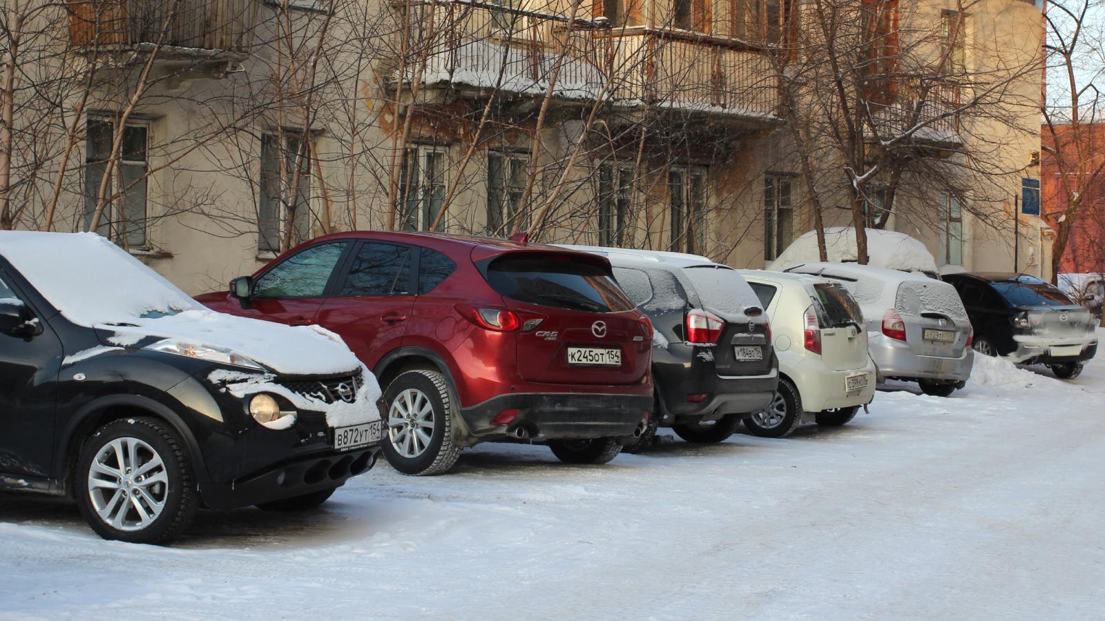 cars parked in a snowy lot
