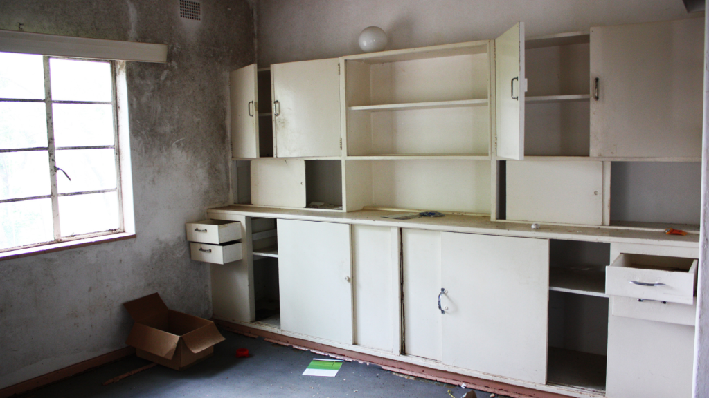 empty cupboards in abandoned kitchen