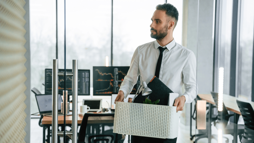 Company Reassured Everyone After the Takeover—But One Worker Quietly Prepared for What He Thought Was Coming fired employee leaving office with a box of personal belongings