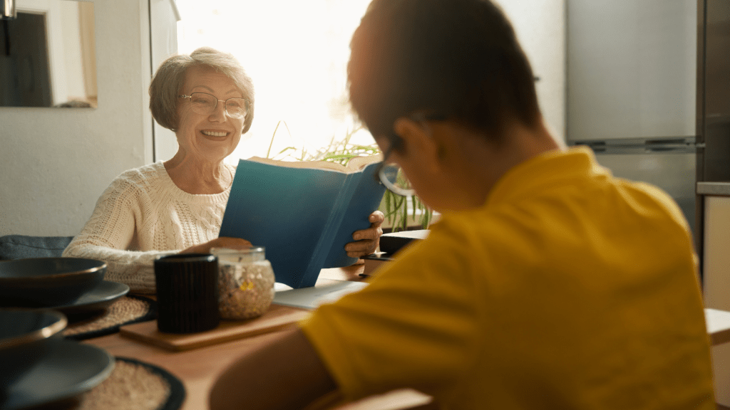 Husband Fired His Mother As The Family Babysitter After She Overreacted To A School Schedule Change And Turned A Small Issue Into Bigger Drama grandmother reading a book with a young boy