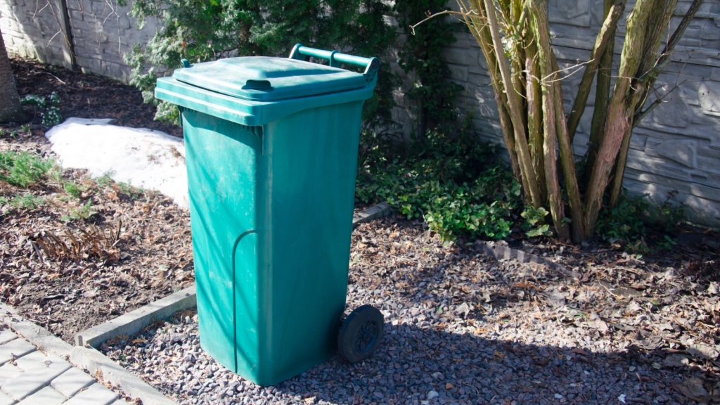 green garbage bin outside