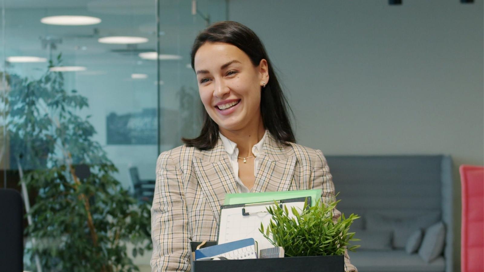 A Boss Demanded She Take the Fall for a Housekeeper’s Alleged Mistake—So She Quit on the Spot and Walked Out Forever happy woman holding a box of stuff