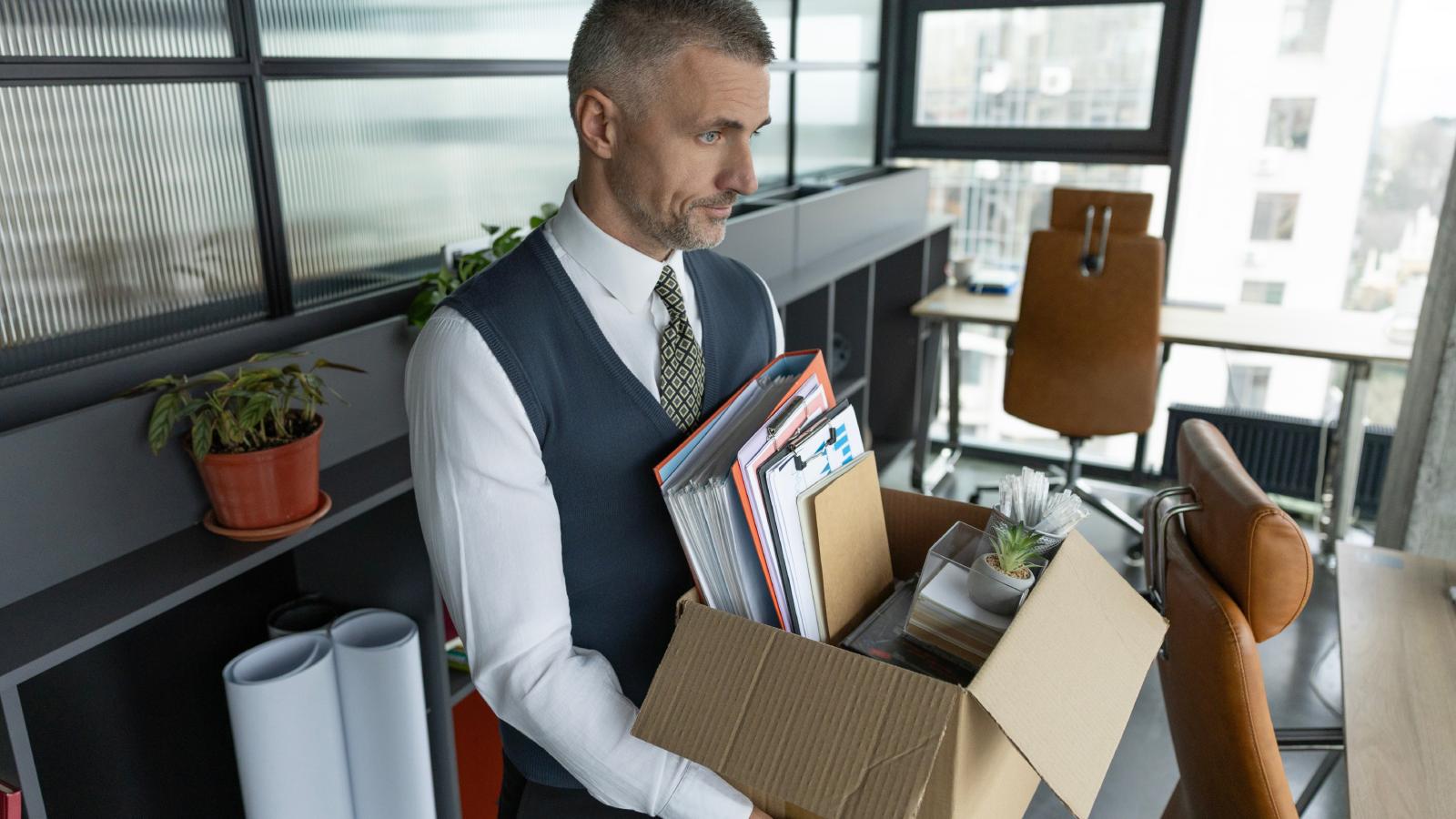 Worker Was Suddenly Laid Off, But His Employer Never Gave Him A Good Reason For Why He Was Let Go man holding a box in his office