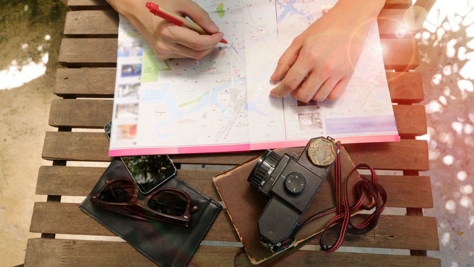 person writing on a travel map