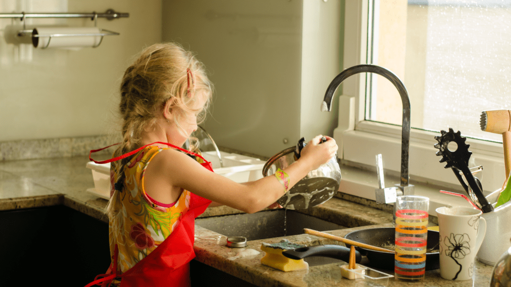 kid washing disgusting dishes frowning very dirty kitchen